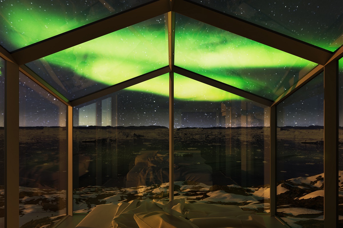 Vanuit de kamer in de Aurora Cabins heb je uitzicht op het prachtige noorderlicht. De glazen hut geeft uitzicht op het fjord in Ilulissat.